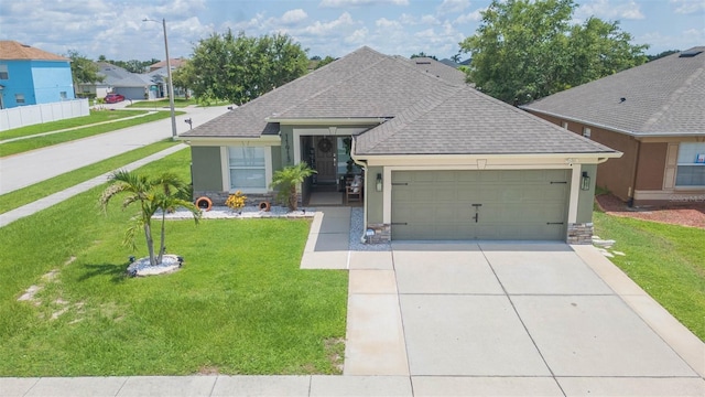 11913 Butler Woods Cir, Riverview, FL 33579 - ranch-style house with an attached garage, roof with shingles, driveway, a front lawn, and stucco siding