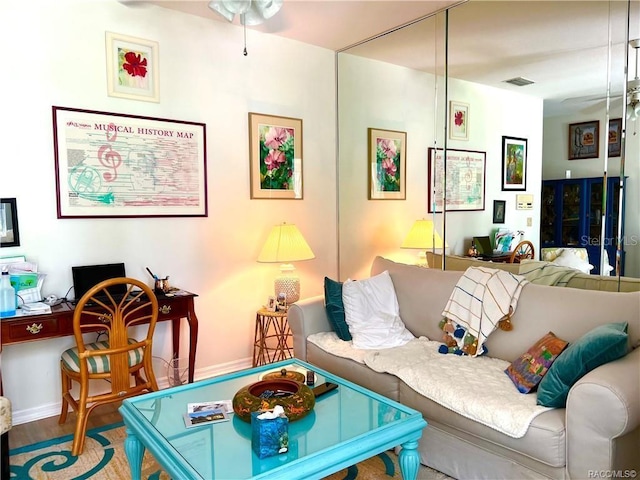 6847 E Queensbury Ln, Inverness, FL 34452 - living area featuring an office area, wood finished floors, and a ceiling fan