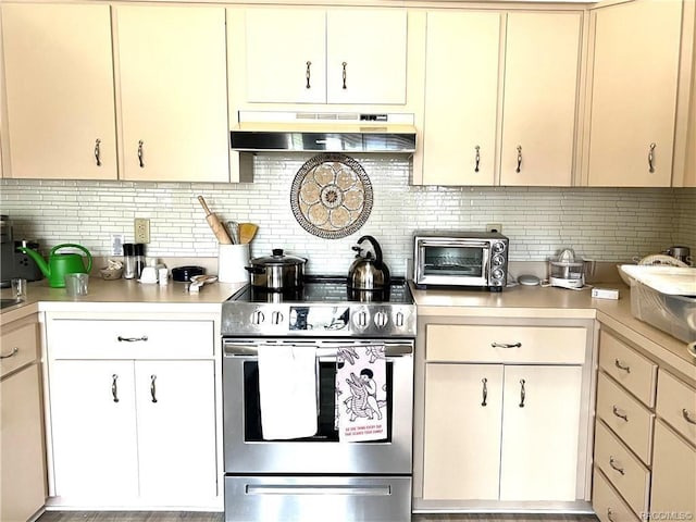 6847 E Queensbury Ln, Inverness, FL 34452 - kitchen with stainless steel electric range oven, under cabinet range hood, light countertops, and decorative backsplash