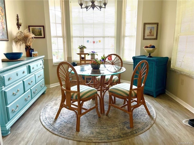 6847 E Queensbury Ln, Inverness, FL 34452 - dining room featuring light wood-style floors and a chandelier