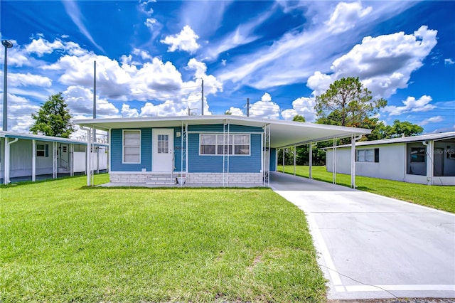 35014 Carl Ave, Zephyrhills, FL 33541 - manufactured / mobile home featuring driveway, a front lawn, and a carport