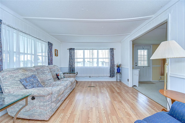35014 Carl Ave, Zephyrhills, FL 33541 - living room with wood finished floors, beam ceiling, and a textured ceiling