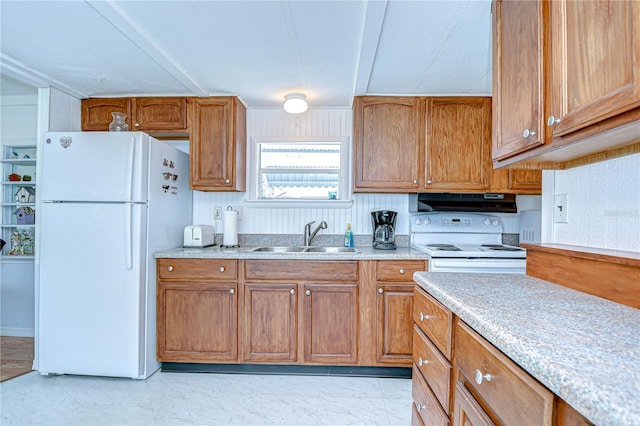 35014 Carl Ave, Zephyrhills, FL 33541 - kitchen with white appliances, light countertops, exhaust hood, and brown cabinets