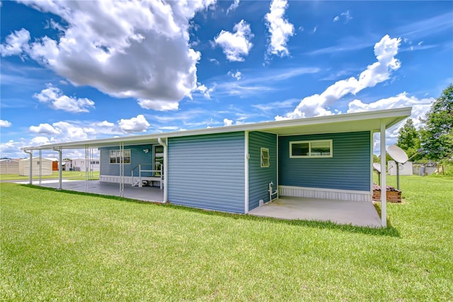 35014 Carl Ave, Zephyrhills, FL 33541 - back of property featuring an attached carport, a patio, and a yard