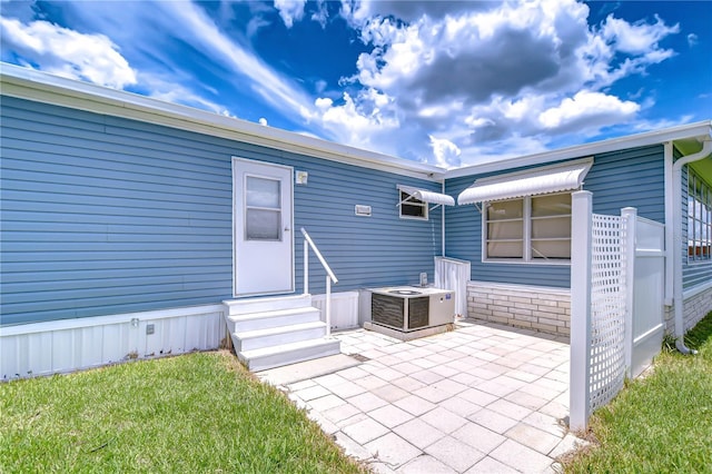 35014 Carl Ave, Zephyrhills, FL 33541 - rear view of house featuring entry steps and a patio area