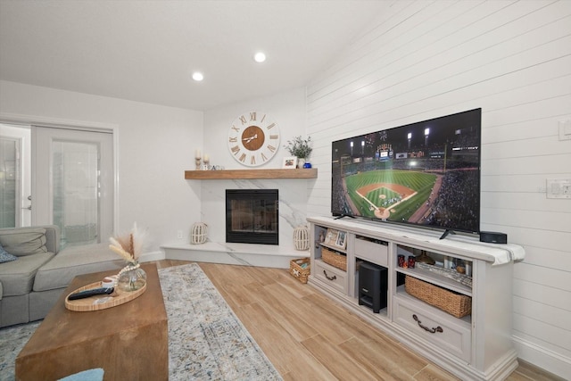 11763 Saree Ct, Largo, FL 33778 - living room featuring wood finished floors, a premium fireplace, recessed lighting, and wooden walls