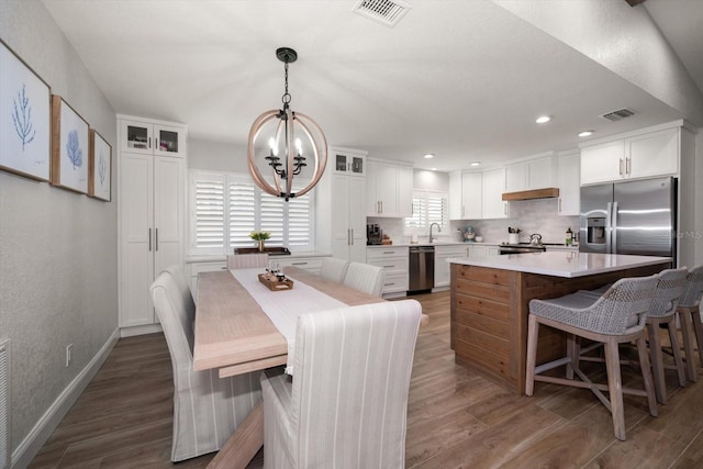 11763 Saree Ct, Largo, FL 33778 - dining area with a chandelier, dark wood finished floors, recessed lighting, and a textured wall