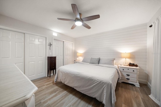 11763 Saree Ct, Largo, FL 33778 - bedroom featuring multiple closets, light wood-style flooring, and ceiling fan
