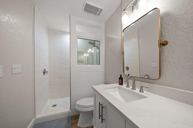 11763 Saree Ct, Largo, FL 33778 - full bathroom with a textured wall, vanity, a tile shower, and wood finished floors