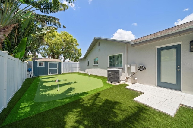 11763 Saree Ct, Largo, FL 33778 - fenced backyard with a putting area, a storage unit, and a patio