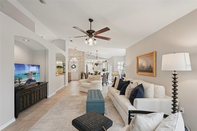 3854 Lyndhurst Ct, Sarasota, FL 34235 - living area with a ceiling fan, light tile patterned floors, vaulted ceiling, arched walkways, and a chandelier