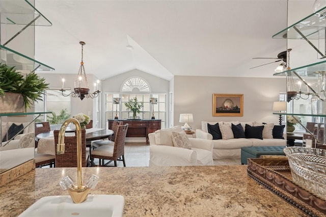 3854 Lyndhurst Ct, Sarasota, FL 34235 - living area featuring a chandelier, vaulted ceiling, and a ceiling fan