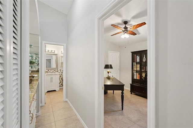 3854 Lyndhurst Ct, Sarasota, FL 34235 - corridor featuring light tile patterned flooring and vaulted ceiling