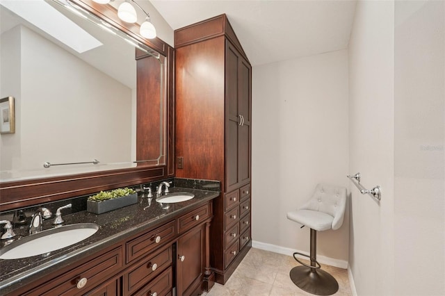 3854 Lyndhurst Ct, Sarasota, FL 34235 - full bath featuring a skylight, double vanity, and tile patterned floors