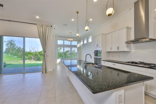 955 Signet Dr, Apollo Beach, FL 33572 - kitchen featuring wall chimney exhaust hood, appliances with stainless steel finishes, backsplash, light tile patterned floors, and a large island with sink