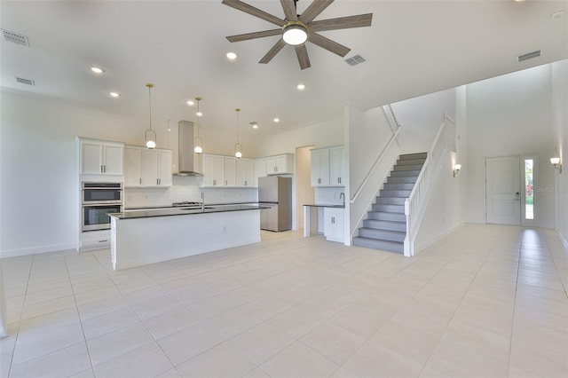 955 Signet Dr, Apollo Beach, FL 33572 - kitchen featuring stainless steel appliances, wall chimney range hood, dark countertops, a ceiling fan, and open floor plan