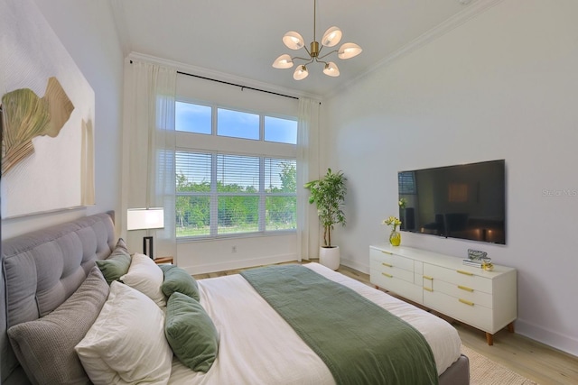 955 Signet Dr, Apollo Beach, FL 33572 - bedroom with crown molding, a chandelier, light wood-style flooring, and lofted ceiling