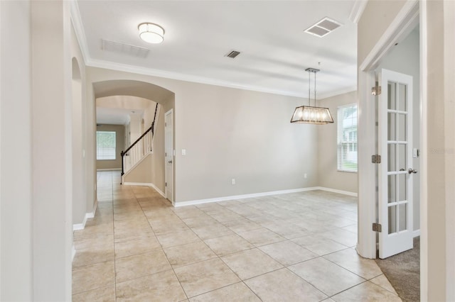 3530 Brook Crossing Dr, Brandon, FL 33511 - unfurnished room featuring crown molding, light tile patterned floors, arched walkways, stairway, and a chandelier