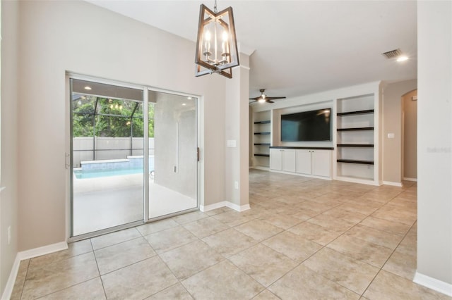 3530 Brook Crossing Dr, Brandon, FL 33511 - spare room with built in features, light tile patterned flooring, a chandelier, a ceiling fan, and arched walkways