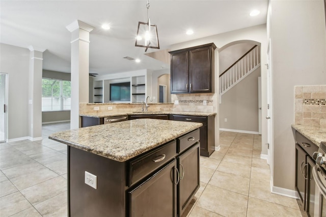 3530 Brook Crossing Dr, Brandon, FL 33511 - kitchen with tasteful backsplash, dark brown cabinetry, light stone countertops, and recessed lighting