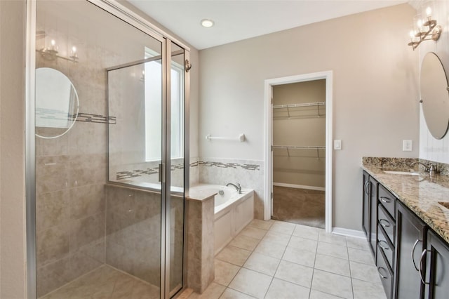 3530 Brook Crossing Dr, Brandon, FL 33511 - full bathroom featuring a stall shower, tile patterned flooring, a bath, double vanity, and a walk in closet