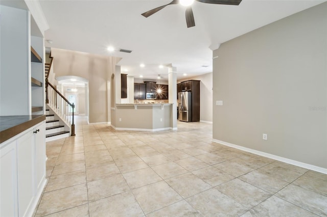 3530 Brook Crossing Dr, Brandon, FL 33511 - unfurnished living room with ceiling fan, light tile patterned floors, stairs, recessed lighting, and arched walkways