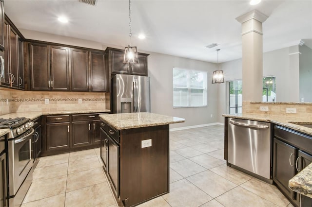 3530 Brook Crossing Dr, Brandon, FL 33511 - kitchen featuring appliances with stainless steel finishes, tasteful backsplash, ornate columns, dark brown cabinets, and recessed lighting