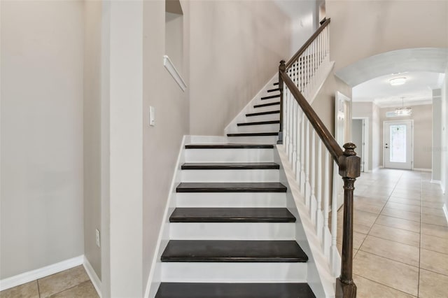 3530 Brook Crossing Dr, Brandon, FL 33511 - stairs with arched walkways, tile patterned floors, and crown molding