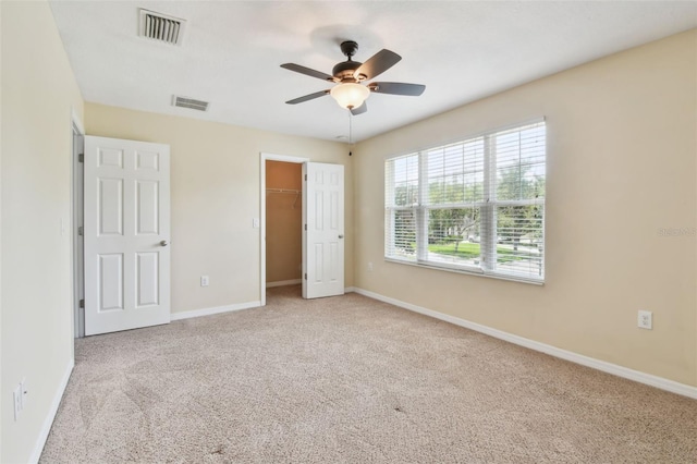 3530 Brook Crossing Dr, Brandon, FL 33511 - unfurnished bedroom with carpet, a ceiling fan, a closet, and a walk in closet