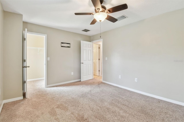 3530 Brook Crossing Dr, Brandon, FL 33511 - unfurnished bedroom featuring a spacious closet, light colored carpet, a ceiling fan, and a closet