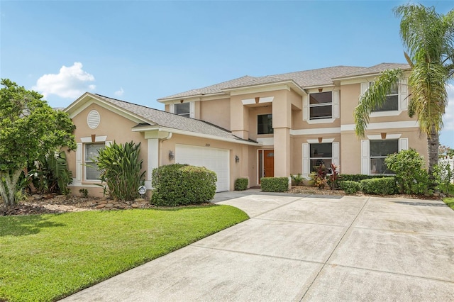 25737 Frith St, Land O Lakes, FL 34639 - view of front of house with stucco siding, a front lawn, concrete driveway, and a garage