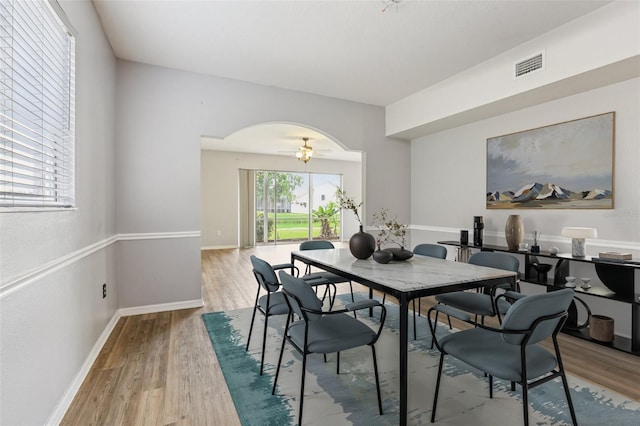 25737 Frith St, Land O Lakes, FL 34639 - dining space featuring arched walkways and wood finished floors