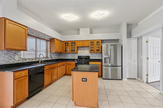 25737 Frith St, Land O Lakes, FL 34639 - kitchen with black appliances, a center island, tasteful backsplash, a textured ceiling, and glass insert cabinets