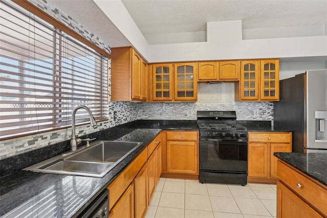 25737 Frith St, Land O Lakes, FL 34639 - kitchen with black gas range oven, stainless steel refrigerator with ice dispenser, light tile patterned floors, brown cabinets, and a textured ceiling
