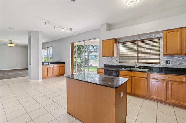 25737 Frith St, Land O Lakes, FL 34639 - kitchen with black dishwasher, backsplash, light tile patterned floors, and a kitchen island
