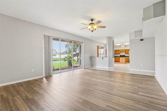 25737 Frith St, Land O Lakes, FL 34639 - unfurnished living room with a ceiling fan and light wood-type flooring