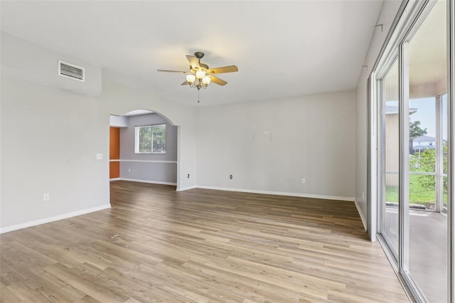 25737 Frith St, Land O Lakes, FL 34639 - spare room with ceiling fan, arched walkways, and light wood-style floors