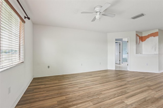 25737 Frith St, Land O Lakes, FL 34639 - empty room with wood finished floors, healthy amount of natural light, and a ceiling fan