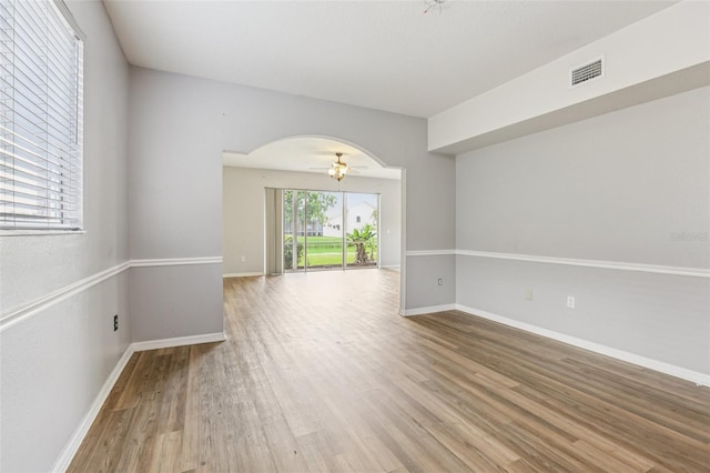 25737 Frith St, Land O Lakes, FL 34639 - empty room featuring wood finished floors, arched walkways, and ceiling fan