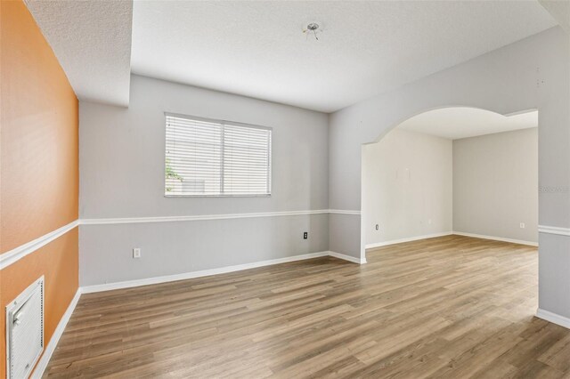25737 Frith St, Land O Lakes, FL 34639 - unfurnished room with wood finished floors and arched walkways