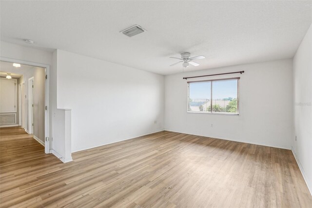 25737 Frith St, Land O Lakes, FL 34639 - empty room with a smoke detector, light wood-type flooring, and a ceiling fan