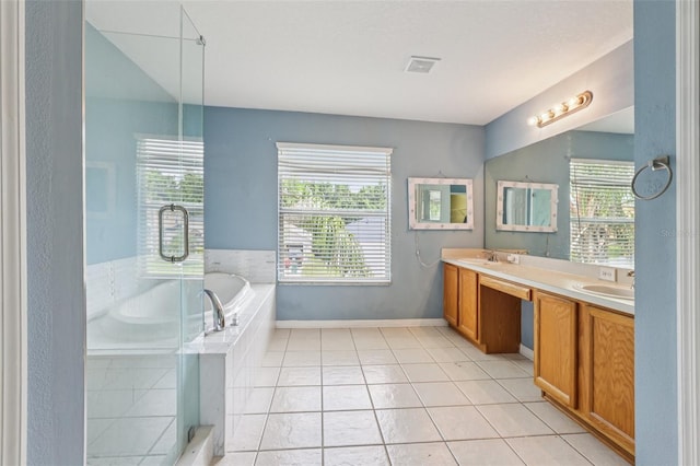 25737 Frith St, Land O Lakes, FL 34639 - bathroom with plenty of natural light, double vanity, a garden tub, and tile patterned floors