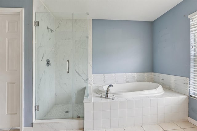25737 Frith St, Land O Lakes, FL 34639 - bathroom featuring a garden tub, a marble finish shower, and tile patterned floors