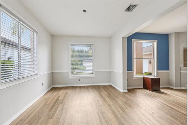 25737 Frith St, Land O Lakes, FL 34639 - empty room featuring light wood finished floors and arched walkways