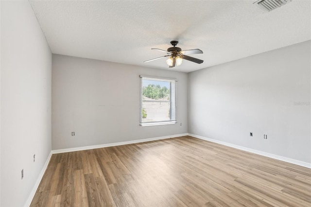 25737 Frith St, Land O Lakes, FL 34639 - unfurnished room with light wood-type flooring, a ceiling fan, and a textured ceiling