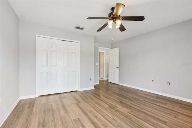 25737 Frith St, Land O Lakes, FL 34639 - unfurnished bedroom with wood finished floors, a closet, and a ceiling fan