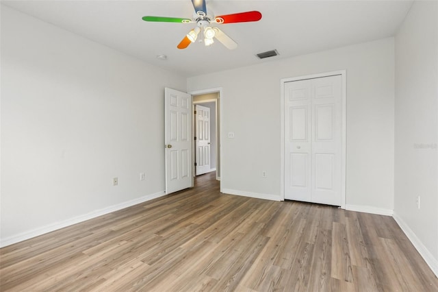 25737 Frith St, Land O Lakes, FL 34639 - unfurnished bedroom featuring light wood-style flooring, a closet, and ceiling fan