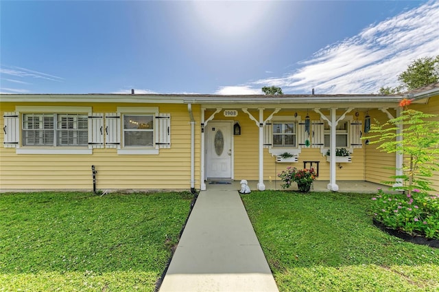 1908 N Brink Ave, Sarasota, FL 34234 - view of front of property with a front lawn and a porch