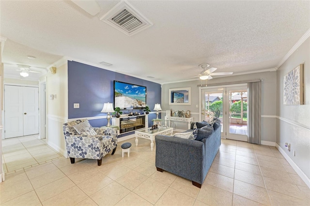 1908 N Brink Ave, Sarasota, FL 34234 - living room featuring a ceiling fan, crown molding, a textured ceiling, and light tile patterned floors