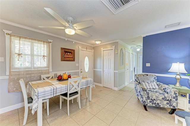 1908 N Brink Ave, Sarasota, FL 34234 - dining space with a textured ceiling, crown molding, light tile patterned flooring, and a ceiling fan